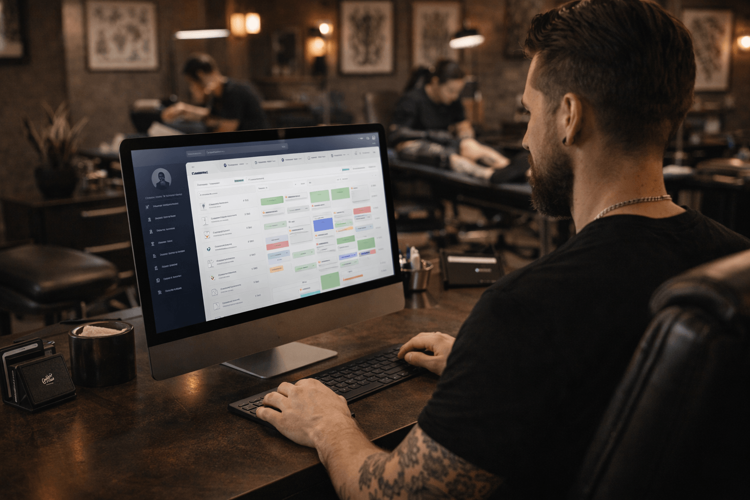 Tattoo studio owner using management software to view client appointments and scheduling dashboard